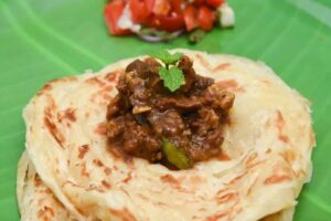Kerala parotta beef curry layered bread — traditional Syrian Christian food 2026